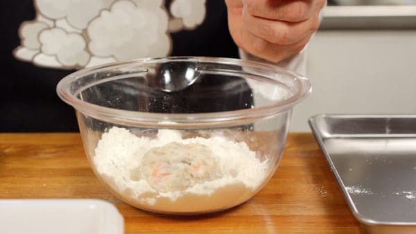 Once all the filling is shaped into circles, remove the gloves and dust them with flour. Use a spatula to transfer the filling into the bowl so it doesn't lose its shape.