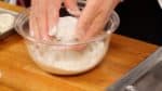 Passe die Form der Füllung in der Schüssel an, während Du die Füllungsscheiben mit Mehl bedeckst. Ausreichend Mehl in der Schüssel macht die Sache einfacher.