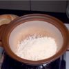 Transférez le riz rincé dans une cocotte en céramique.