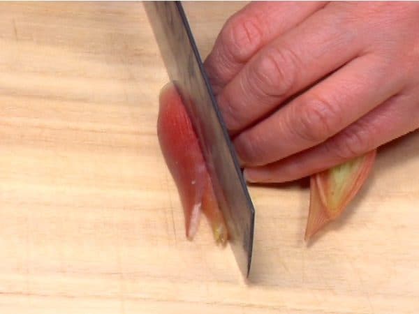 Cut the myoga ginger bud lengthwise in quarters.
