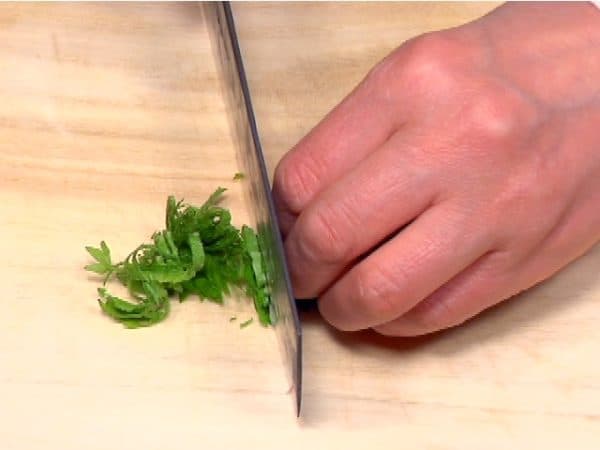 Roll them up and then and chop into thin strips.