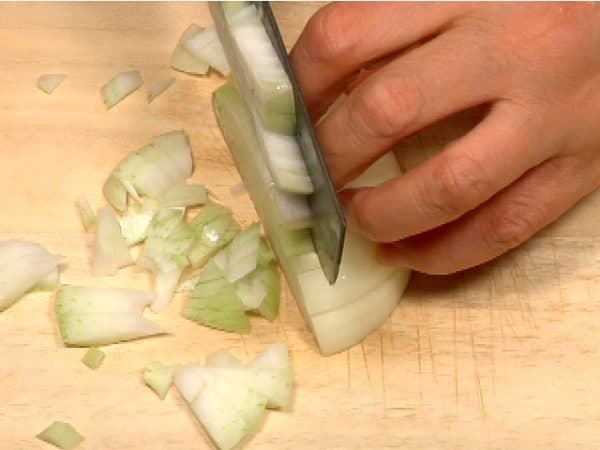 Rotate the onion and make cuts perpendicular to the initial cuts. Chop one whole onion into roughly-chopped pieces.