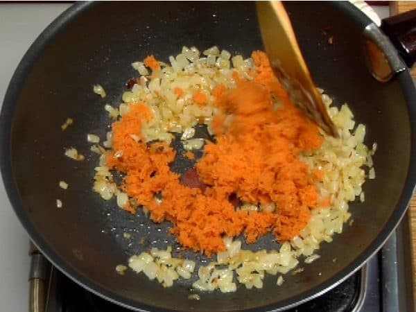 Add the grated carrot. Stir-fry it 2 to 3 more minutes.