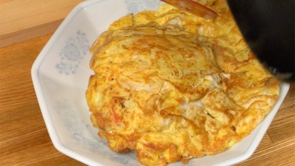 And then quickly place the omelet onto the rice.
