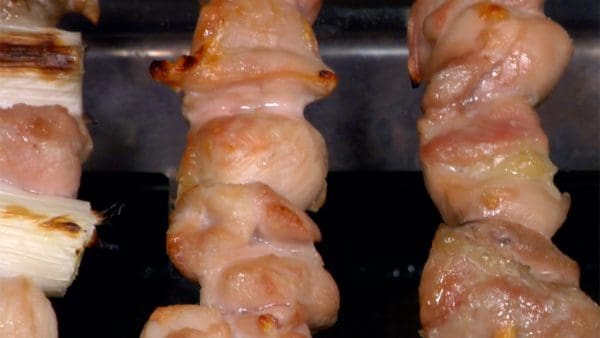 Flip the yakitori over to cook evenly.