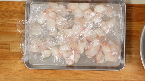 Wrap the fish with plastic wrap and store it in the freezer until partially frozen.