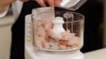 Next, let’s make the surimi, ground fish meat. Place the partially frozen sea bream and pacific cod in the food processor.