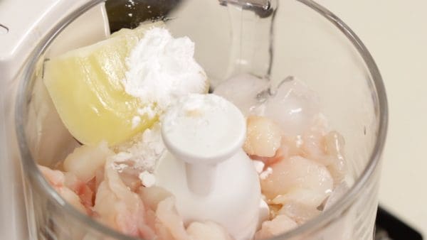 Add the salt, frozen egg white, sugar, potato starch and 3 ice cubes. Make sure to use a food processor that can crush the ice cubes. Furthermore, let the ice sit at room temperature to help it crush easily.