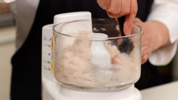 Using a spatula, wipe the sides of the bowl to gather the surimi in the middle again.