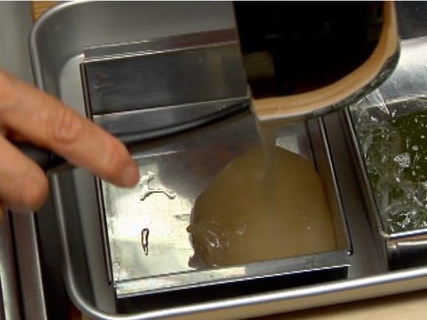 Transfer the hot mixture to another wet shallow baking pan.