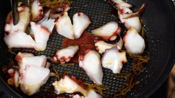 Now, add the octopus slices. Toss to coat with the sauce quickly to prevent the octopus from getting tough.