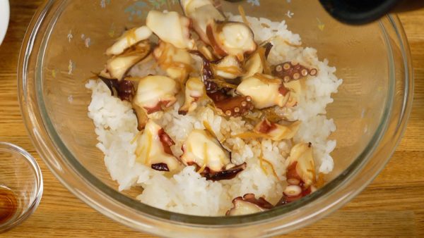 Then, place the octopus mixture into a bowl of hot steamed rice cooked with a little less water.