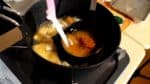 Next, put the miso into a ladle and place it into the pot. Ladle the dashi stock a little and dissolve the miso in the ladle. This will help dissolve the miso completely.