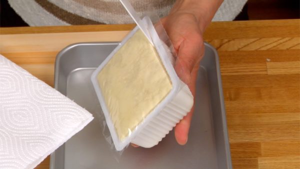 Let’s remove the excess water from the tofu. Remove the tofu block from the package.