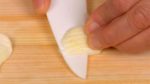 Make vertical cuts in the garlic, slice across the initial cuts and then chop the garlic clove into fine pieces.