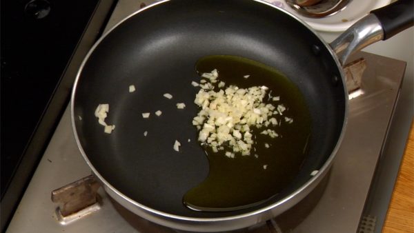 Put the olive oil and chopped garlic in a small pan and turn on the burner.