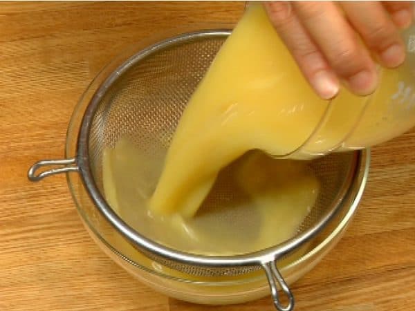 Strain the egg mixture with a mesh strainer.