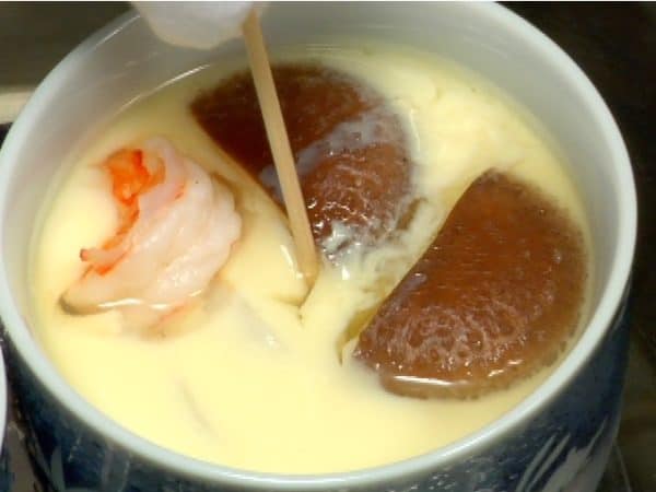 Pierce the egg mixture with a bamboo skewer. If the broth is clear, the chawanmushi is ready to serve.