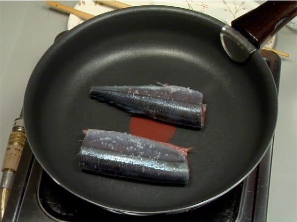 Turn on the burner and place the fish into a frying pan.
