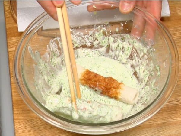 Dip the chikuwa, tube-shaped fish cake, into the batter.