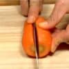 Cut off the stem end of the carrot and cut the carrot in half lengthwise.