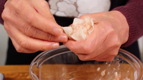 And form the shumai into a cylindrical shape by squeezing it.