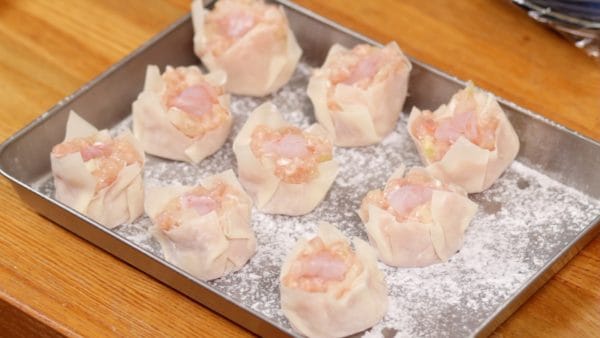 Place the shumai onto a tray lightly covered with potato starch. The potato starch will help to avoid sticking.
