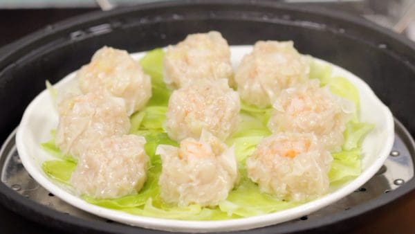 Now, they should be ready. If you are not sure if they are cooked thoroughly, split one of the shumai in half and check the inside.