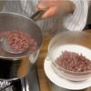 Pinch 2 or 3 azuki beans to ckeck the firmness. When the beans are soft enough to be crushed, scoop out about half of the azuki beans (250 g / 8.8 oz) and transfer them to a bowl with a mesh strainer. These azuki beans will be used to make Anko, sweet bean paste later.