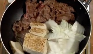 Next, add the napa cabbage leaves, yaki dofu, grilled firm tofu and ito konnyaku.