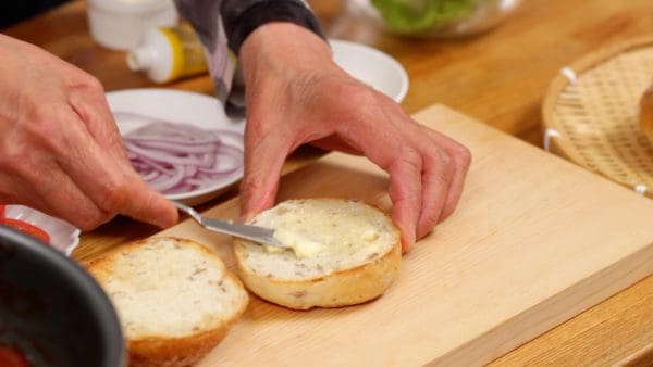 Spread butter on each cut generously. This will keep the buns from absorbing the moisture from the vegetables and sauce.