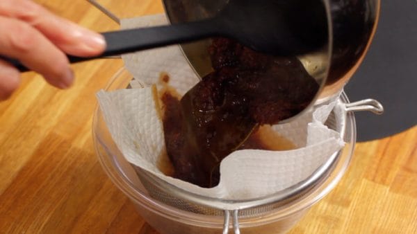 Remove the pot and strain the sauce through a mesh strainer covered with a paper towel. Let it sit to cool.