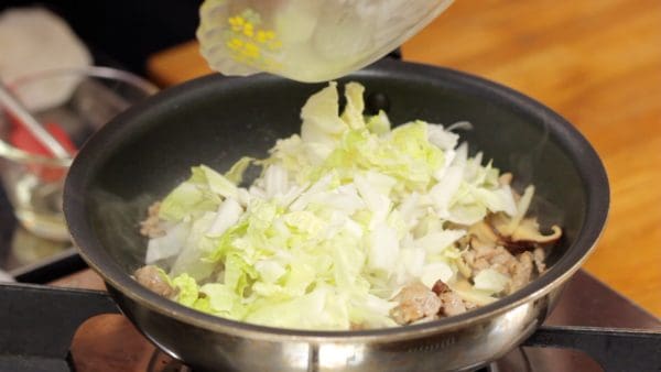 Add the napa cabbage and continue to stir-fry. Cook them slowly, letting the water evaporate as well.