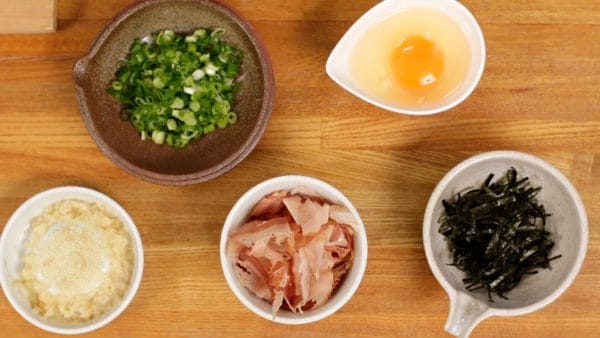 Here are some other seasonings, grated ginger root, Katsuobushi also known as bonito flakes, packaged shredded nori seaweed, and finely chopped spring onion leaves. You can also add the egg yolk to taste.