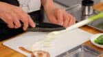 接下來，讓我們切蔬菜。用斜切法將長蔥 （Naganegi） 切成 1 厘米（0.4 英寸）厚的薄片。