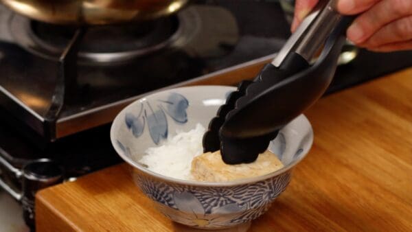 Prepare a bowl of warm rice and place the tofu onto it.