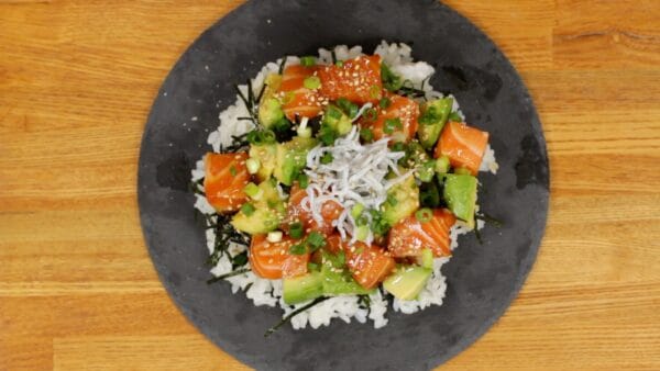 Sprinkle toasted white sesame seeds all over. Top with the chopped spring onion leaves.