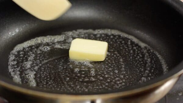 Add the butter and coat the pan with it. Either salted or unsalted butter can be used.