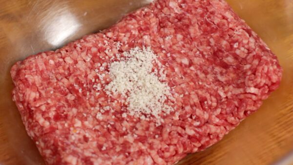 Add the salt to the ground beef and pork and mix.