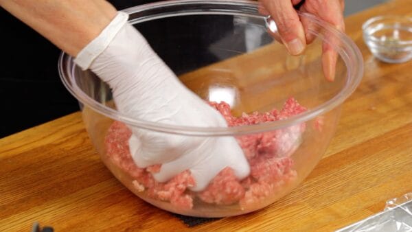 Mix it thoroughly until the meat becomes gooey. Wearing food-grade gloves will help prevent the meat from getting warm with your hands.
