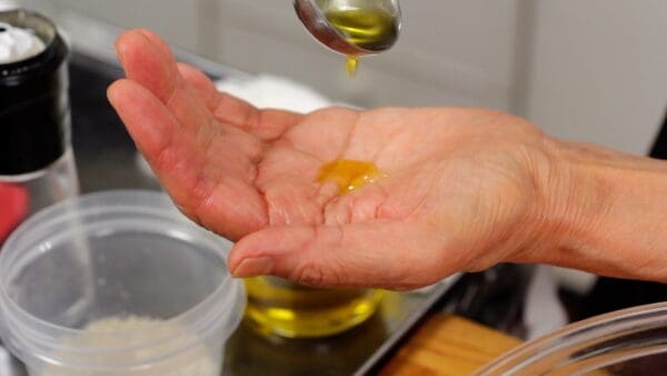 Coat your hands with olive oil.