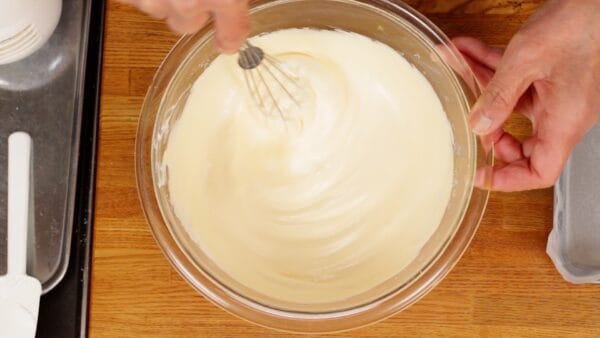 Mix it thoroughly with a balloon whisk until the white meringue begins to turn yellow.