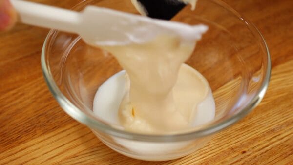 When the surface becomes glossy, add a small amount of the airy batter to the lukewarm milk.
