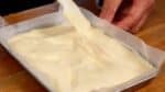 Then, spread the batter along the edges of the tray to give it an even thickness. You might want to rotate the tray to make it easier to work with.