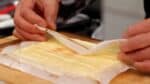 Then, turn it over and remove the parchment paper from the bottom.