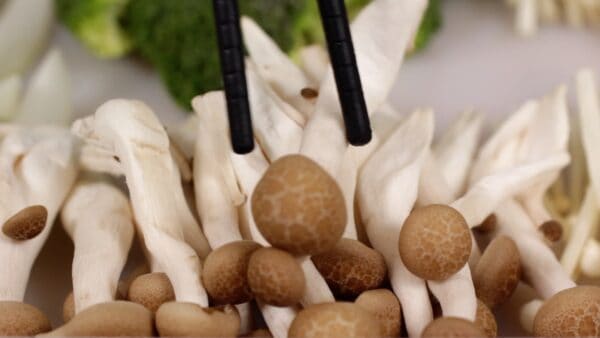 Tear the shimeji mushrooms into smaller pieces.