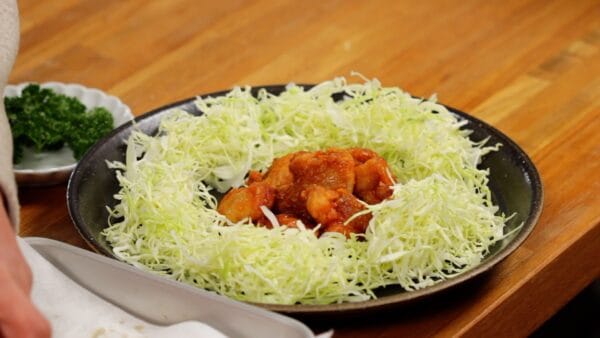 Arrange plenty of shredded cabbage on a plate. Pile up the spicy chicken karaage in the middle. The well-seasoned fried chicken is delicious on its own, without any sauce or toppings.