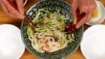 To enjoy Morioka Jajamen, mix the noodles and toppings thoroughly.