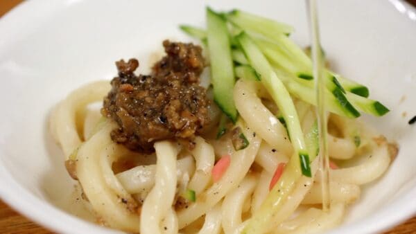 For the second bowl, add more meat miso mixture and shredded cucumber. Finally, pour over vinegar for a refreshing taste.