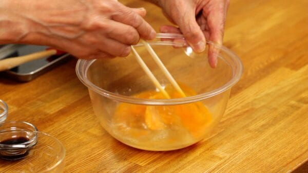 Then, add the dashi mixture to the eggs. Using chopsticks, dissolve the sugar first, and then mix all the ingredients together.